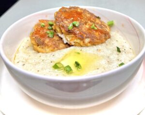 salmon croquettes on top of buttery grits in a bowl